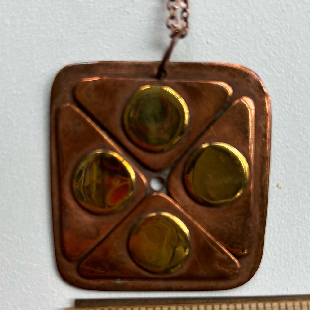 Copper and brass pendant with copper colored chain (16”). Handmade and well made